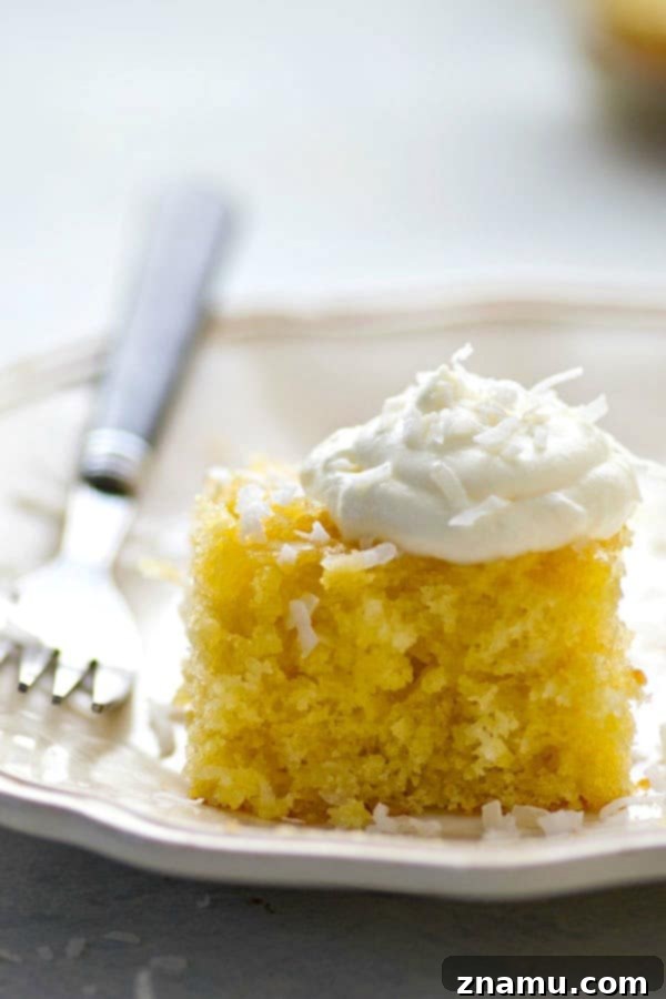 Pina Colada Escape Poke Cake 5 Overhead view of a prepared Pina Colada Poke Cake in a baking dish
