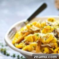 Flavorful shiitake mushrooms are incredibly good paired with a rich garlic butter sauce, sharp Asiago cheese, and lots of cheese-filled tortellini in this killer garlic butter Asiago tortellini skillet!
