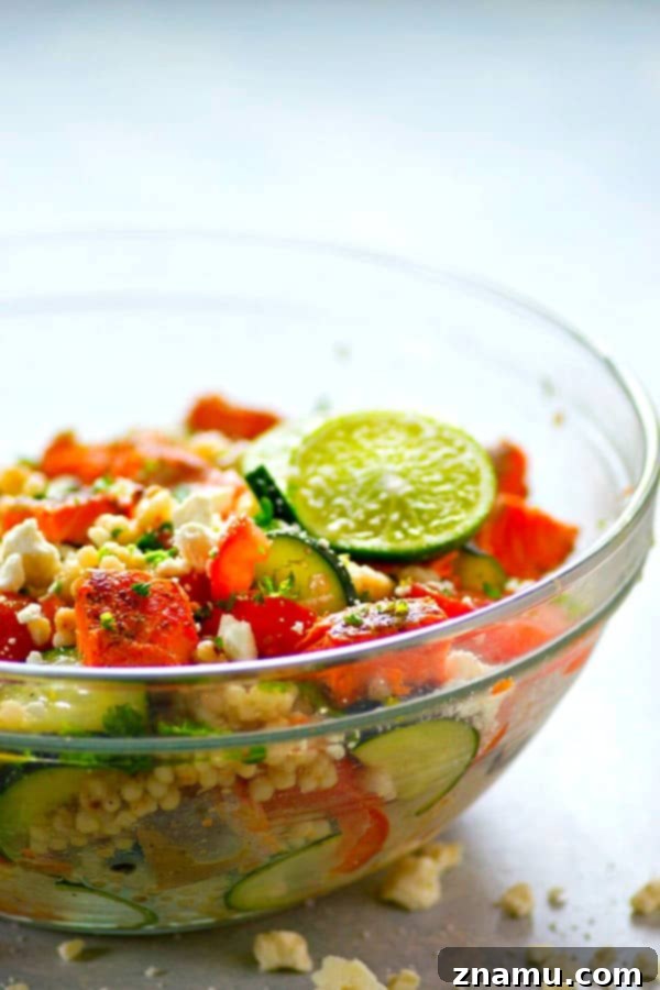 Overhead shot of a large bowl filled with Greek Salmon Couscous Salad, ready to be served