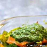 Smothered in flavorful basil pesto and roasted with broccoli and sweet peppers, this pesto baked salmon is on the dinner table in MINUTES and super filling, yet light on the carbs!