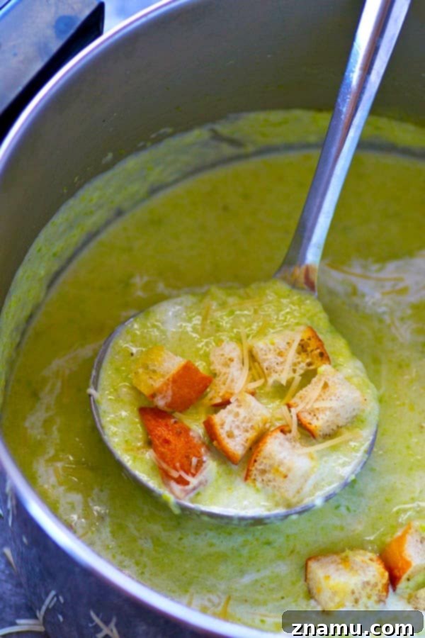 Close-up of creamy asparagus soup with golden Parmesan croutons on top