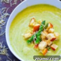 Insanely creamy, yet light cream of asparagus soup is a DREAM paired with crispy Parmesan croutons piled on top! This soup is perfect for using up all that asparagus.