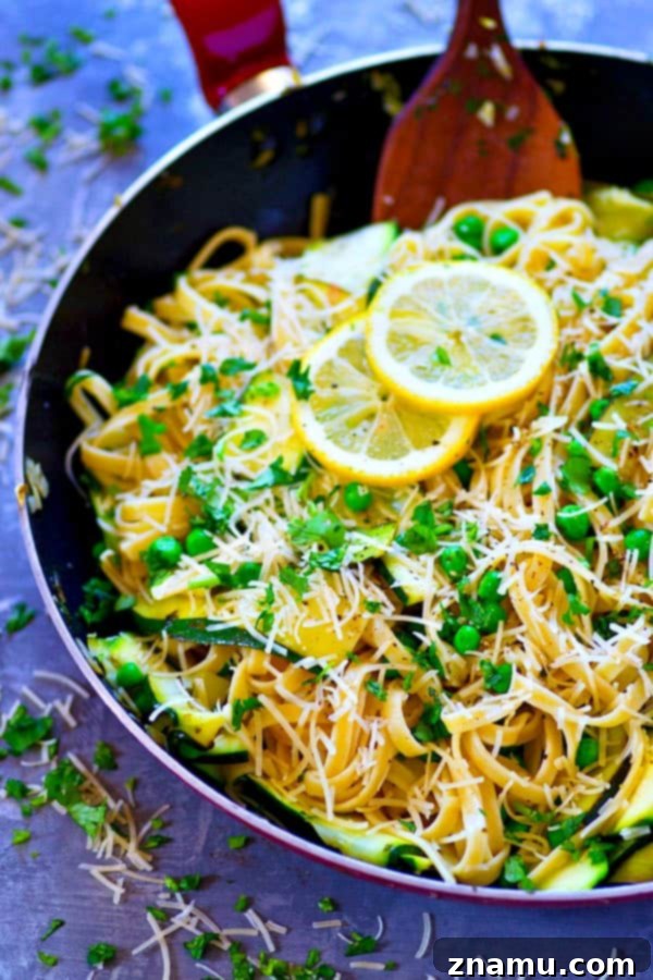 Bright Lemon Parmesan Fettuccine with Zucchini Ribbons and Spring Peas 3 Close-up of creamy Lemon Parmesan Fettuccine, showing off the rich sauce and tender ingredients.