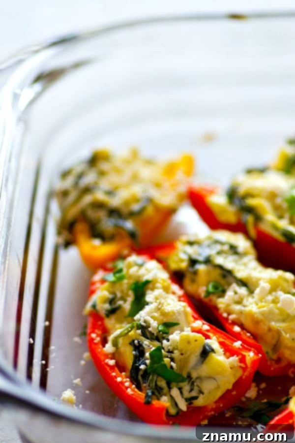 Roasted Spinach Artichoke Feta Stuffed Peppers 3 Close-up of a perfectly baked spinach artichoke feta stuffed sweet pepper, showing its creamy filling and vibrant color