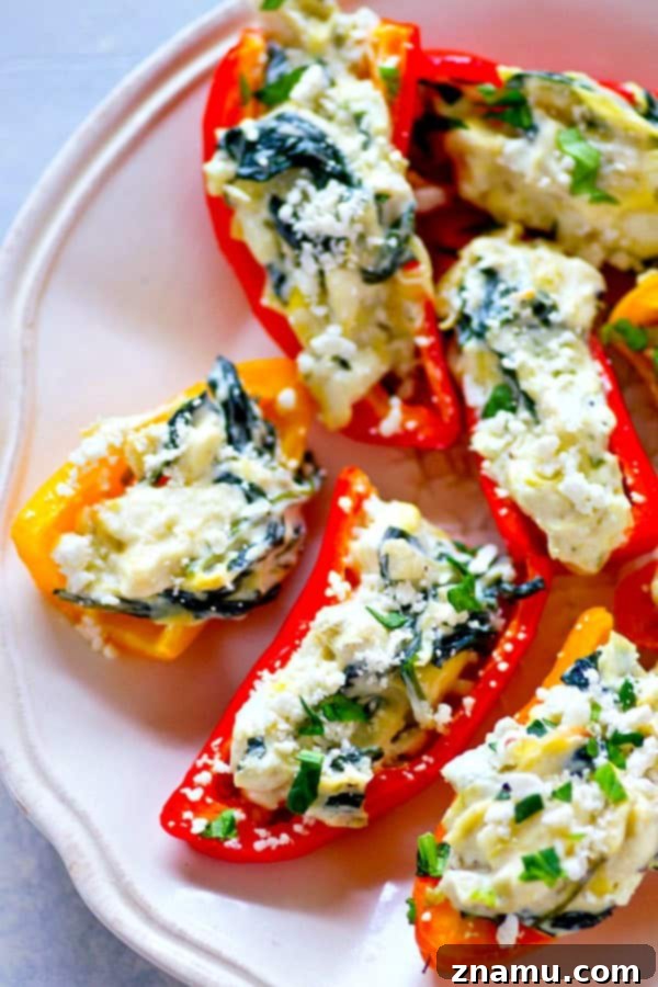 Roasted Spinach Artichoke Feta Stuffed Peppers 4 Preparing the creamy spinach artichoke and feta filling in a mixing bowl before stuffing the sweet peppers