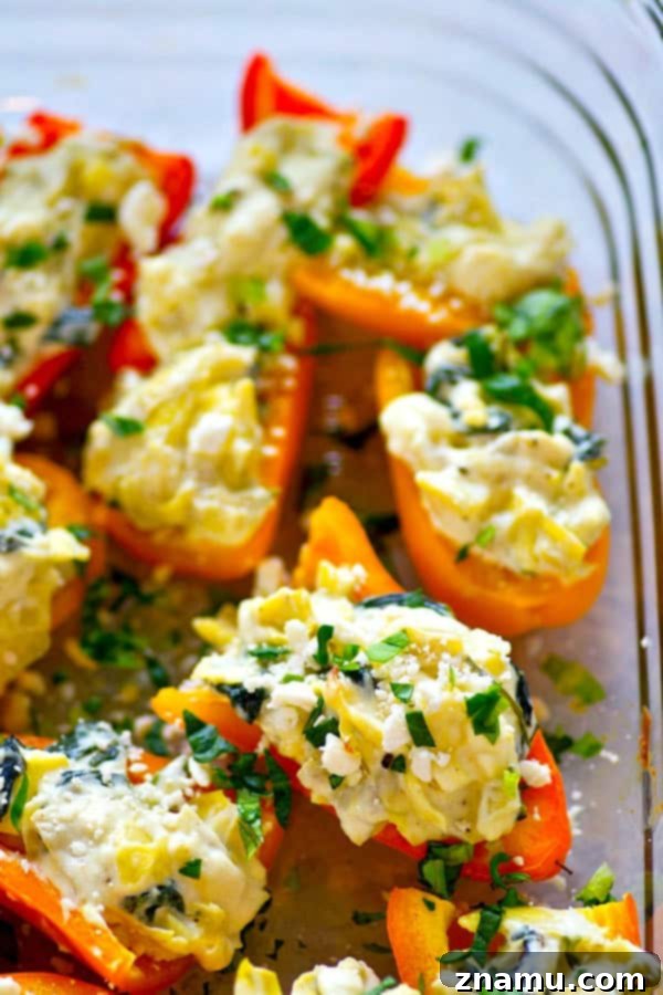 Roasted Spinach Artichoke Feta Stuffed Peppers 5 A baking sheet filled with spinach artichoke feta stuffed mini peppers, ready to be put in the oven