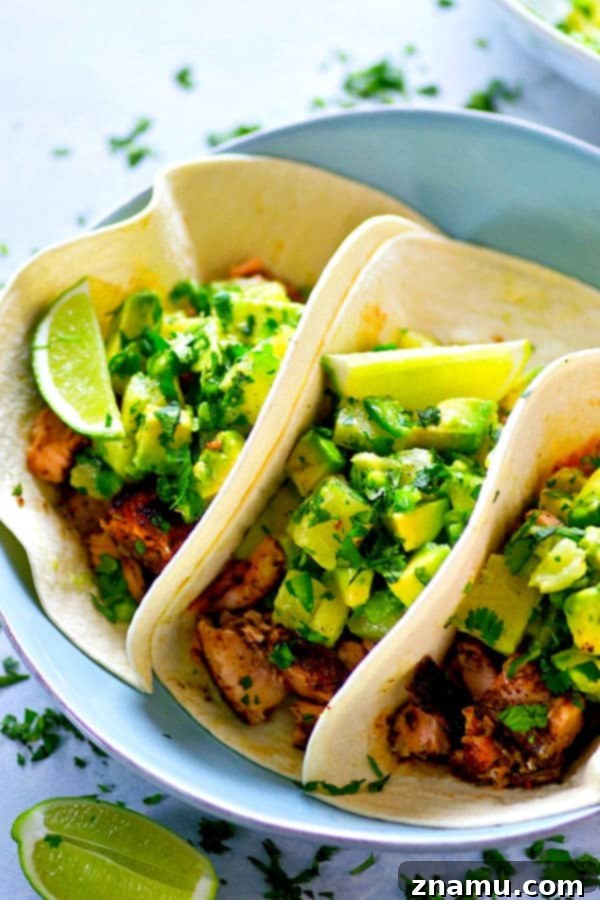 A smokey homemade jerk seasoning coats every inch of these jerk grilled salmon tacos that are heaped in soft flour tortillas and piled high with tangy avocado pineapple salsa!