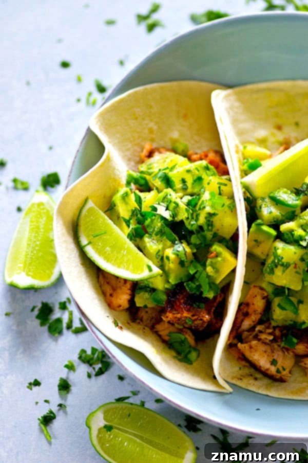 A smokey homemade jerk seasoning coats every inch of these jerk grilled salmon tacos that are heaped in soft flour tortillas and piled high with tangy avocado pineapple salsa!