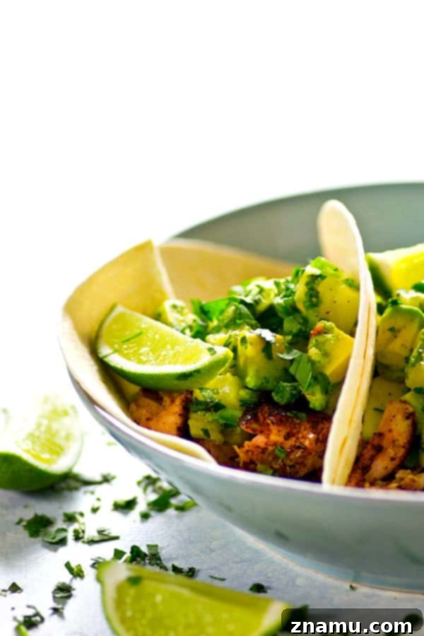 A smokey homemade jerk seasoning coats every inch of these jerk grilled salmon tacos that are heaped in soft flour tortillas and piled high with tangy avocado pineapple salsa!