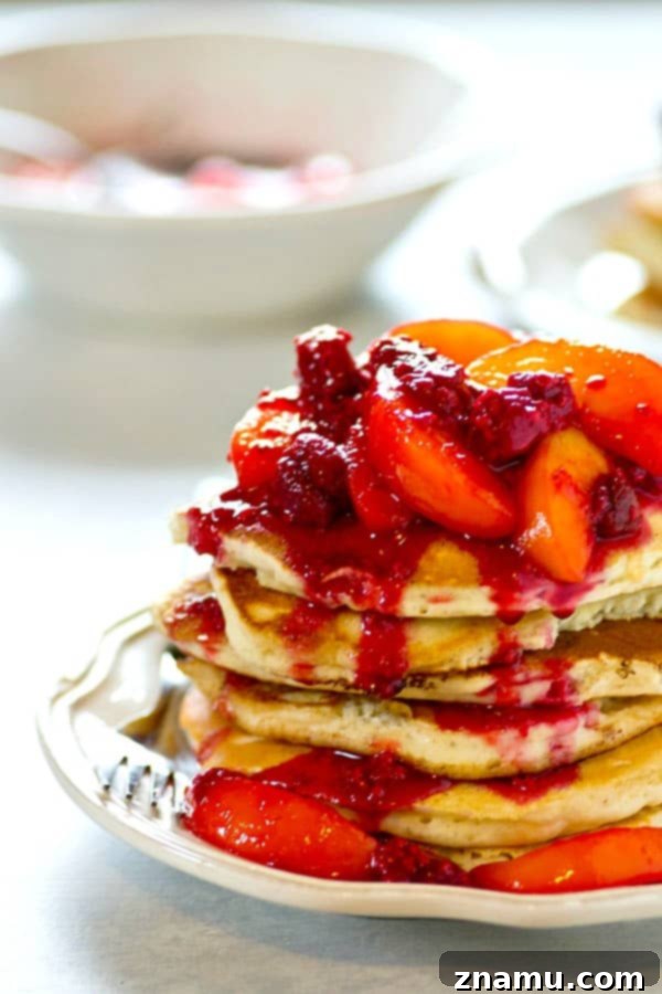 Heavenly Peach Raspberry Sour Cream Stacks 2 Tall stack of incredibly light and fluffy sour cream pancakes with fresh peach raspberry topping