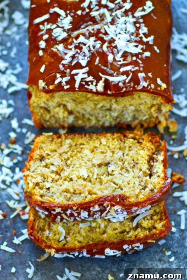 Decadent Salted Caramel Coconut Banana Bread 3 Close-up of a slice of salted caramel coconut banana bread, showing its moist texture and coconut flakes.