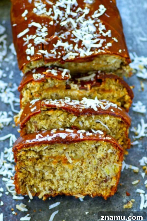 Decadent Salted Caramel Coconut Banana Bread 5 Close-up of a hand drizzling rich salted caramel glaze over a slice of coconut banana bread.