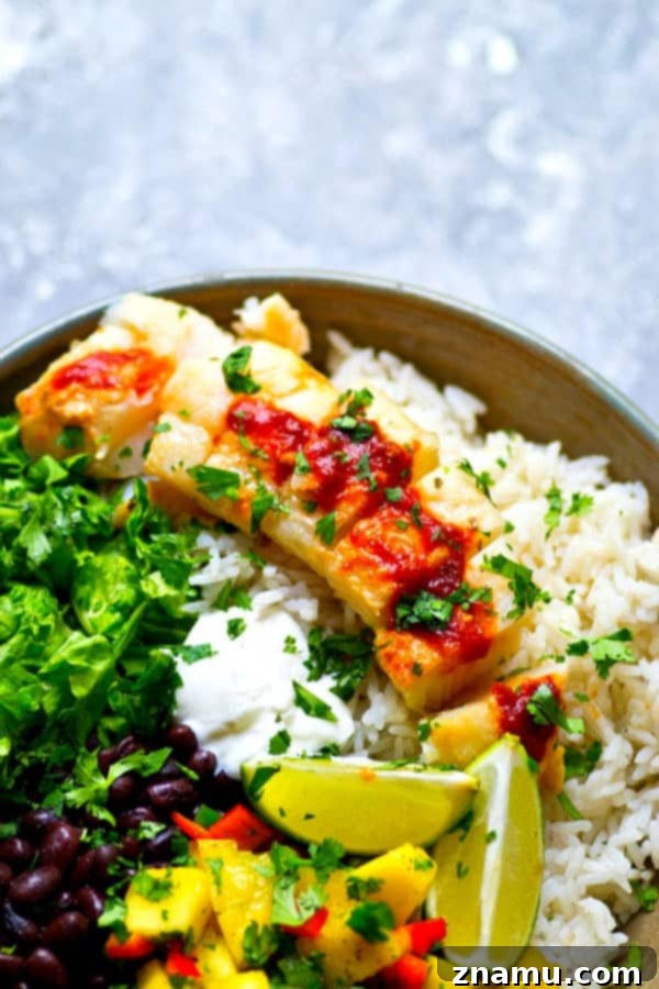 Overhead shot of a meticulously arranged Chipotle Fish Taco Rice Bowl, showcasing the colorful ingredients.