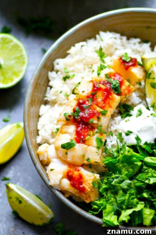 A close-up view of the tender, seared chipotle-marinated fish in a rice bowl.