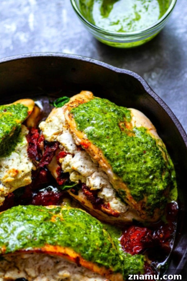 Chimichurri-Drizzled Chicken with Sun-Dried Tomato and Goat Cheese Stuffing 4 A cutting board with ingredients for the stuffing: sun-dried tomatoes, fresh spinach, and minced garlic.