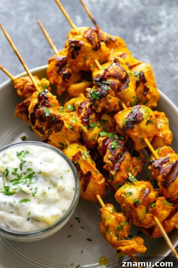 Ultimate Grilled Tandoori Chicken Skewers 2 Hands down the BEST grilled tandoori chicken skewers you will ever throw on the grill this summer. The secret is in the SUPER flavorful long marinade and homemade tzatziki sauce.