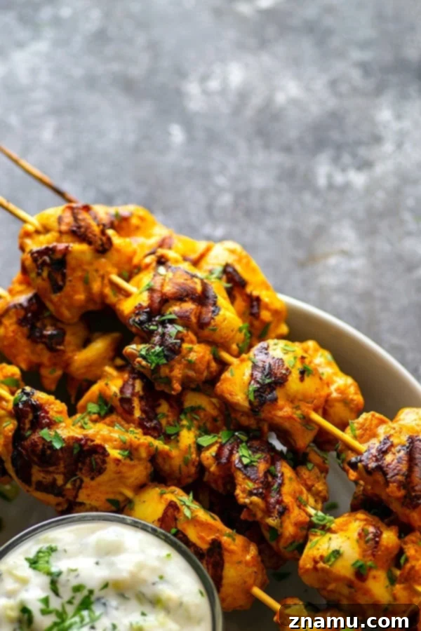 Ultimate Grilled Tandoori Chicken Skewers 5 Hands down the BEST grilled tandoori chicken skewers you will ever throw on the grill this summer. The secret is in the SUPER flavorful long marinade and homemade tzatziki sauce.