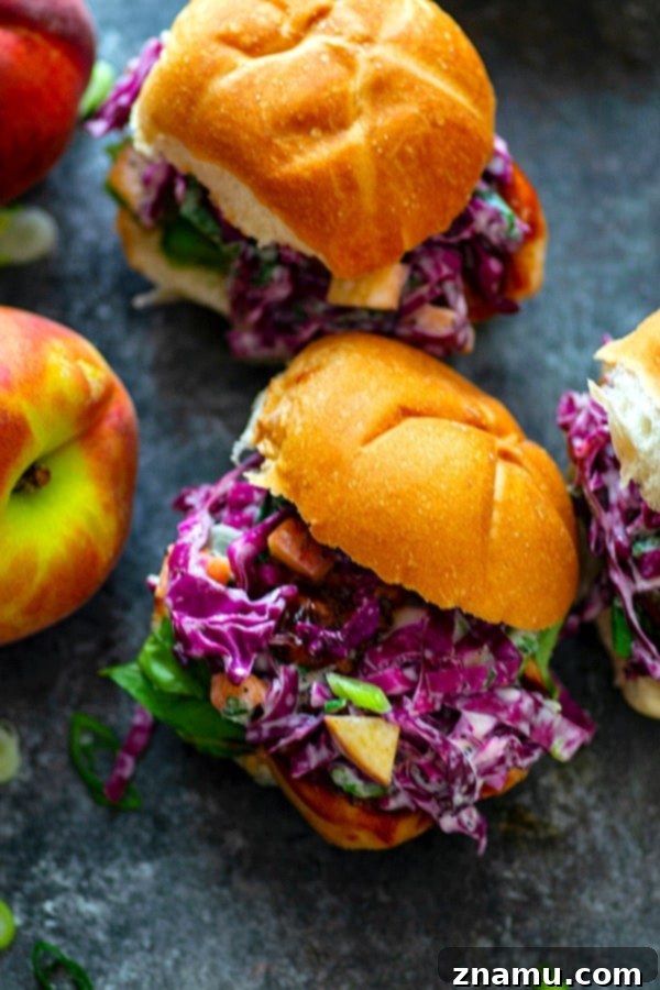Peach Scallion Slaw BBQ Chicken Sliders 5 Hand holding a Barbecue Chicken Slider, demonstrating the generous filling and deliciousness