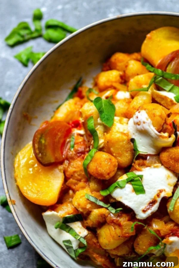 Juicy roasted heirloom tomatoes and creamy fresh mozzarella make the most amazing flavor duo in this summery mozzarella gnocchi skillet that you'll have on the table in MINUTES!