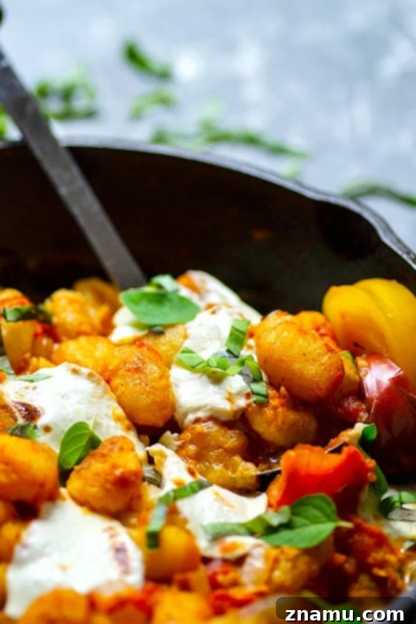 Juicy roasted heirloom tomatoes and creamy fresh mozzarella make the most amazing flavor duo in this summery mozzarella gnocchi skillet that you'll have on the table in MINUTES!