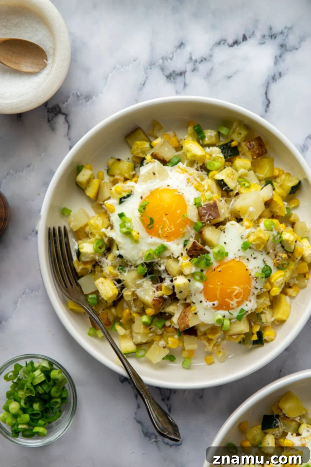Sunny Summer Squash & Sweet Corn Sheet Pan Hash 2 A vibrant Sheet Pan Sweet Corn Summer Squash Breakfast Hash with tender veggies, crispy potatoes, and sunny-side up eggs, ready to be enjoyed.