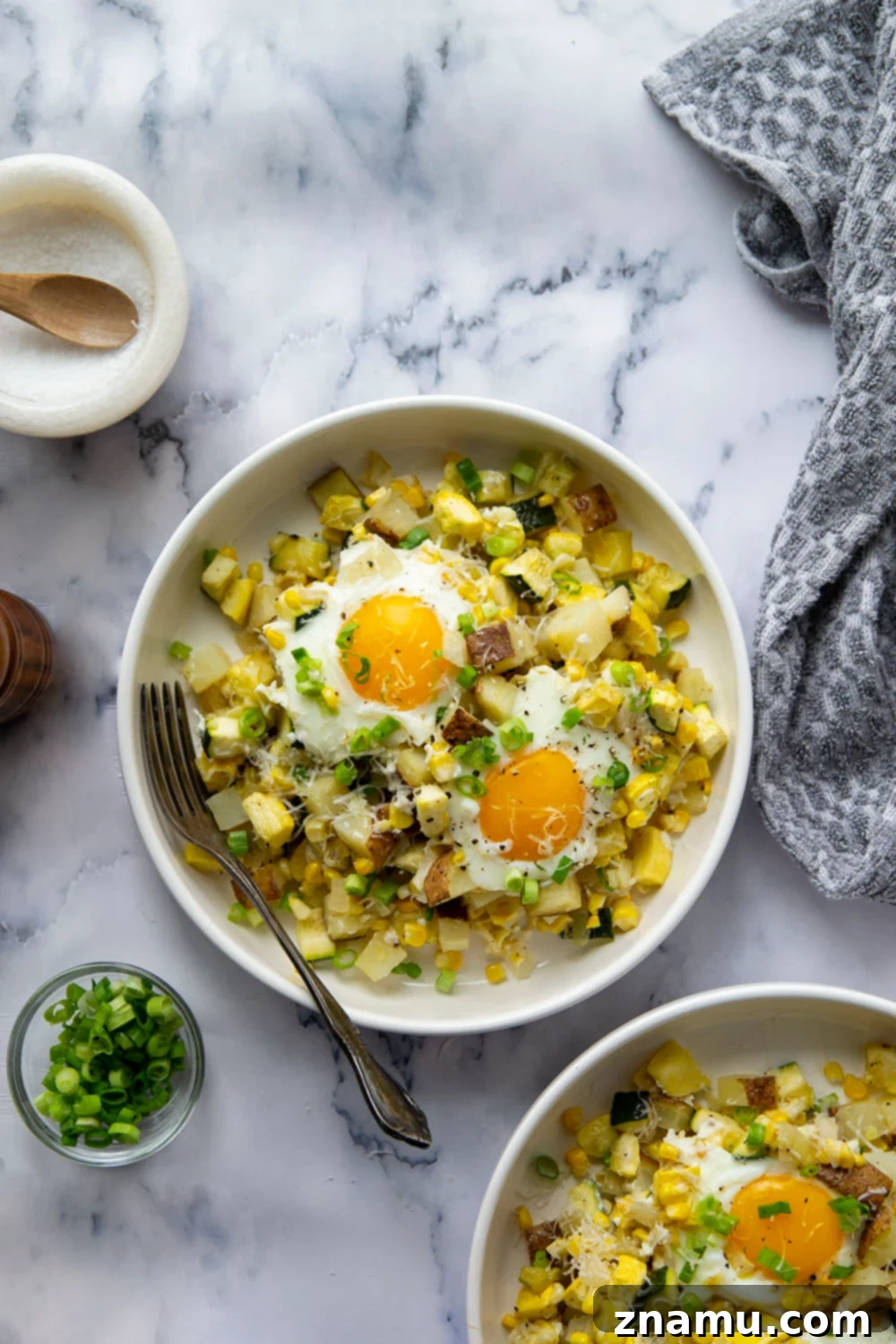 Sunny Summer Squash & Sweet Corn Sheet Pan Hash 5 Various chopped summer vegetables, including zucchini, squash, and corn, tossed with herbs and butter, ready for roasting.