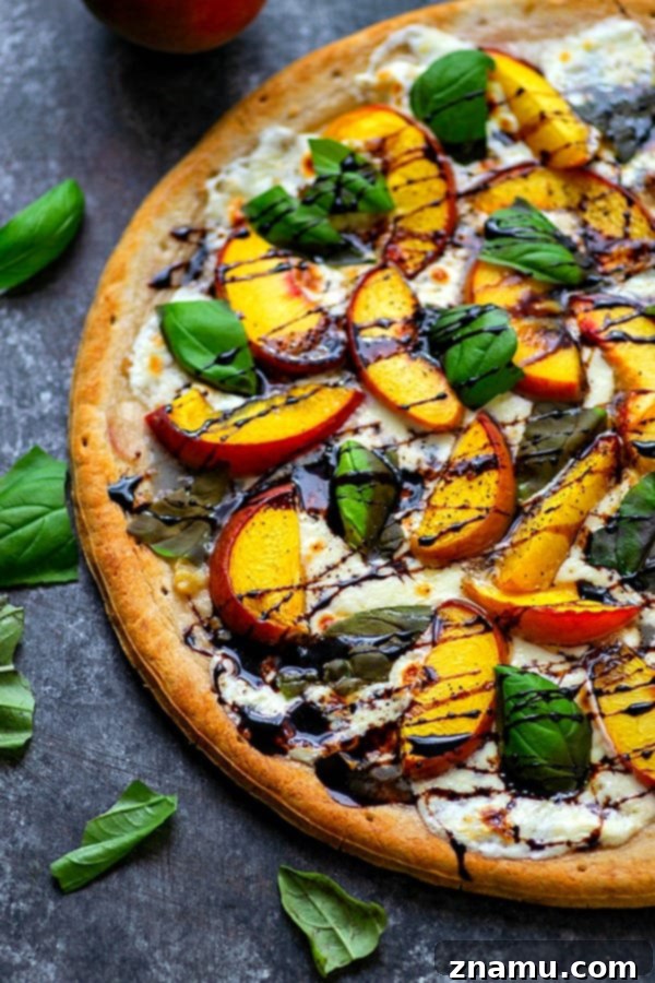 Peachy Balsamic Caprese Pizza 4 Close-up of a slice of Balsamic Peach Caprese Pizza, highlighting the thick balsamic glaze glistening over the peaches and mozzarella.