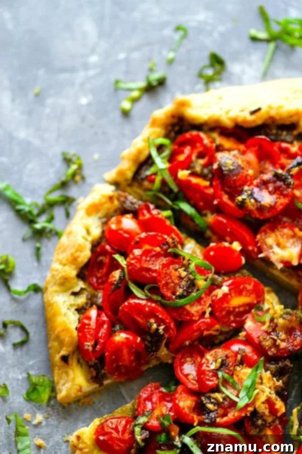 Ricotta Basil Pesto Cherry Tomato Tart 4 Ricotta Basil Pesto Cherry Tomato Galette cooling on a wire rack, with a view of the rustic folded crust.