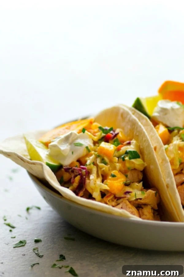 Citrus-Grilled Chicken Tacos with Mango Jalapeno Slaw - Juicy citrus-marinated grilled chicken and a zingy fresh mango jalapeno slaw are the taco duo your taco dinner game NEEDS!