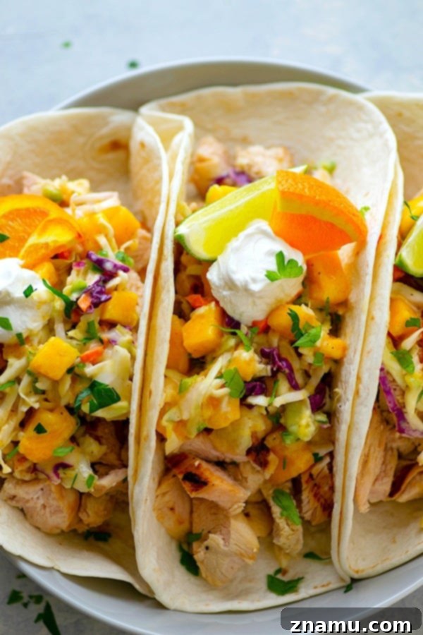 Citrus-Grilled Chicken Tacos with Mango Jalapeno Slaw - Juicy citrus-marinated grilled chicken and a zingy fresh mango jalapeno slaw are the taco duo your taco dinner game NEEDS!