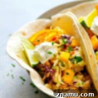 Citrus-Grilled Chicken Tacos with Mango Jalapeno Slaw - Juicy citrus-marinated grilled chicken and a zingy fresh mango jalapeno slaw are the taco duo your taco dinner game NEEDS!
