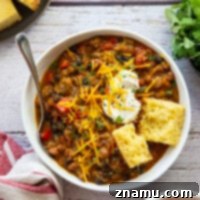 Creamy pumpkin pairs perfectly with two kinds of beans and ground beef in this hearty pumpkin chili! Ready in minutes and amazing loaded up with all your favorite chili toppings.