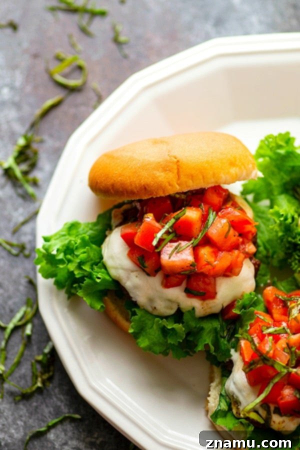 Bruschetta Caprese Burgers 3 Basil Bruschetta Mozzarella Burgers - Juicy, melty mozzarella burgers are piled high with a flavorful basil bruschetta topping for the BEST summer burger any cookout could ask for!