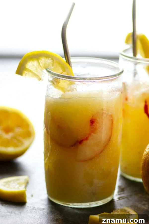 Spiked Peach Lemonade Slush 4 Fresh peaches and lemons, key ingredients for the Frozen Peach Rum Lemonade Slushie, laid out on a wooden surface.