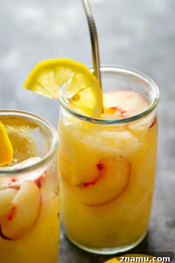 Spiked Peach Lemonade Slush 5 A refreshing Frozen Peach Rum Lemonade Slushie, ready to be enjoyed on a hot summer day.
