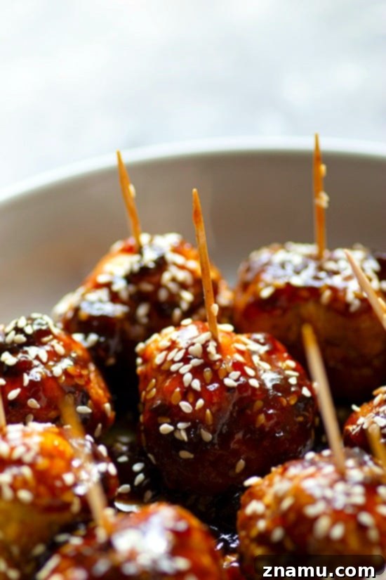 Instant Pot Sticky Honey Sesame Chicken Meatballs 4 Honey Sesame Glazed Chicken Meatballs in Instant Pot - Golden-brown chicken meatballs simmering in a rich honey sesame sauce inside an Instant Pot, ready to be served.