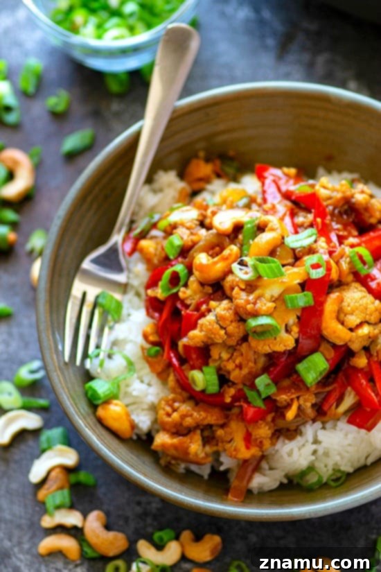 Close-up view of Miso Sweet Pepper Cashew Cauliflower Stir-Fry with fluffy white rice, ready to be enjoyed
