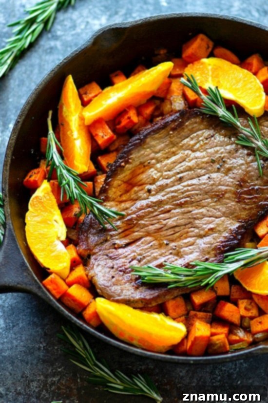 One-Pan Orange Rosemary Steak and Sweet Potatoes plated - Juicy oranges and fragrant rosemary join forces in this weeknight-friendly one-pan orange rosemary steak roasted with tender sweet potatoes in an incredible orange rosemary sauce!