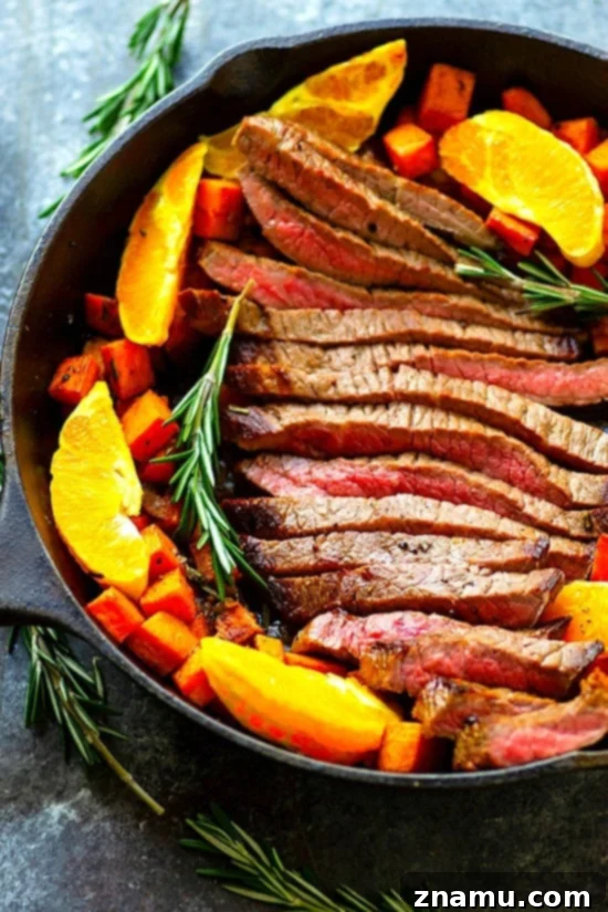 Plated One-Pan Orange Rosemary Steak and Sweet Potatoes with fresh oranges - Juicy oranges and fragrant rosemary join forces in this weeknight-friendly one-pan orange rosemary steak roasted with tender sweet potatoes in an incredible orange rosemary sauce!