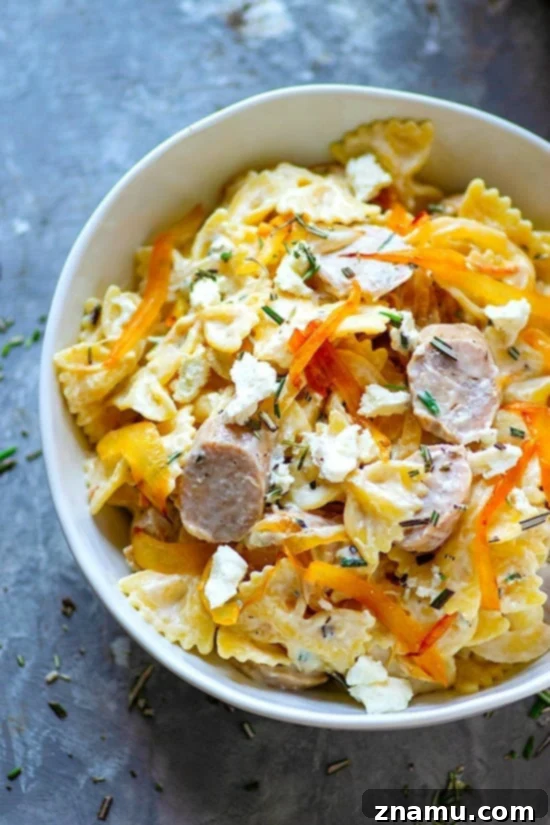 Caramelized Onion and Sausage Farfalle with Creamy Chèvre 3 A close-up shot of the creamy goat cheese bow ties pasta, showcasing its rich texture and appetizing ingredients.