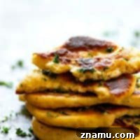 Restaurant-Style Garlic Herb Naan Bread - Impossibly soft and pillowy restaurant-style garlic herb naan bread is SUPER easy to make at home and the best side to any curry or rice dish!