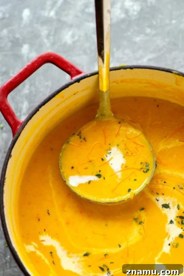Velvet Pumpkin Beer Cheese Soup 4 Freshly roasted pumpkin halves on a baking sheet, showcasing the tender, golden flesh ready to be scooped out for the soup.