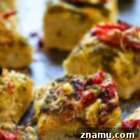 Roasted Garlic Sun-Dried Tomato Pesto Focaccia - Tangy sun-dried tomatoes and nutty roasted garlic deliver MASSIVE flavors in this incredibly soft pesto focaccia! Making it overnight makes it SO easy to prepare.
