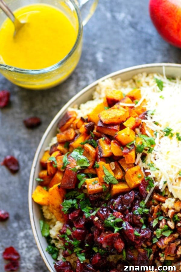 Cranberry Apple Delicata Squash Quinoa Salad - Loaded with tangy cranberries and crunchy apples, this delicata squash quinoa salad is the perfect winter side salad for any gathering and doubles as fantastic lunch leftovers!