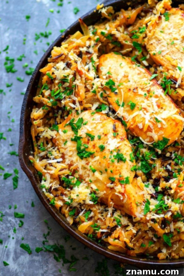 Serving of One-Pot Caramelized Onion Chicken Wild Rice - A hearty and wholesome meal with a generous sprinkle of fresh parsley and Parmesan cheese.