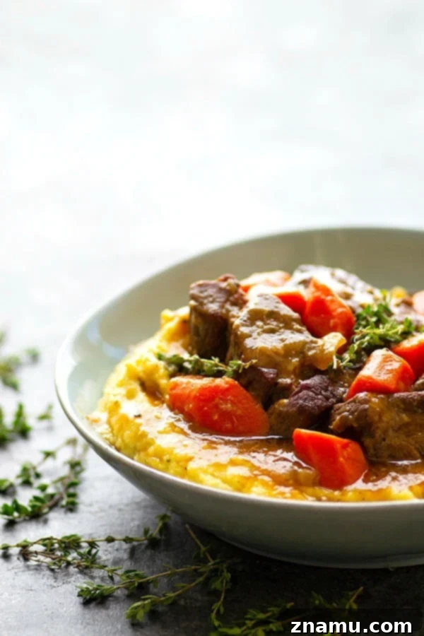 Fork-Tender Stout Ribs with Velvety Mascarpone Polenta 5 A bowl of creamy mascarpone polenta topped with stout-braised beef short ribs.