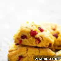 Cranberry Cornmeal Orange Scones - Tangy cranberries and tons of orange flavor take these rustic cranberry scones to the next level! Easy to make for holiday brunch and SO pretty on a brunch table!