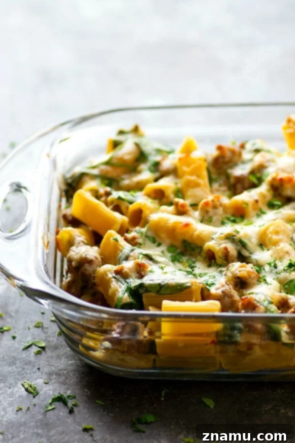 Creamy Alfredo Sausage and Spinach Ziti Bake 3 Close-up of baked ziti with spinach, sausage, and white alfredo sauce