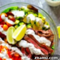Hearty Carne Asada Bowls with Bold Bleu Cheese 7 Carne Asada Steak Salad Bowls - A zingy jalapeno lime steak marinade makes for the most FLAVORFUL carne asada steak salad bowls! Serve this loaded steak salad with all the salad fixins' and creamy bleu cheese dressing.
