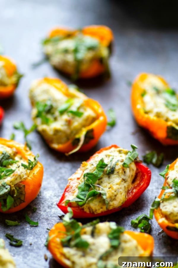 Mini Pesto Sweet Pepper Poppers 2 Pesto Stuffed Sweet Pepper Poppers - Stuffed with a super flavorful creamy pesto filling, these pesto stuffed sweet pepper poppers are SUPER addicting and the perfect little party app!